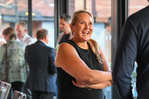 A guest laughing during the drinks reception.