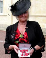 Chief executive collects MBE for services to business
