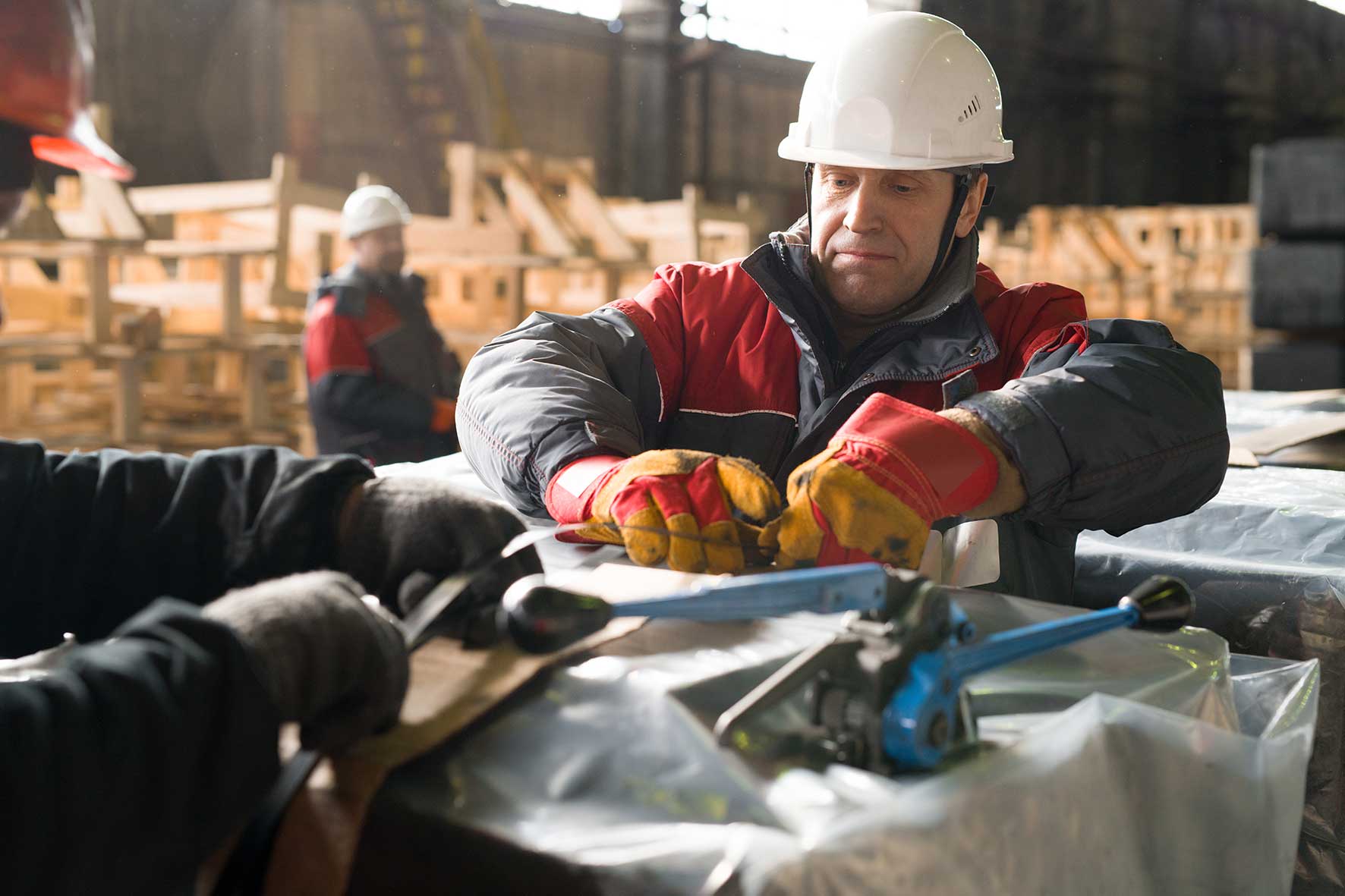 Factory worker unpacking a pallet
