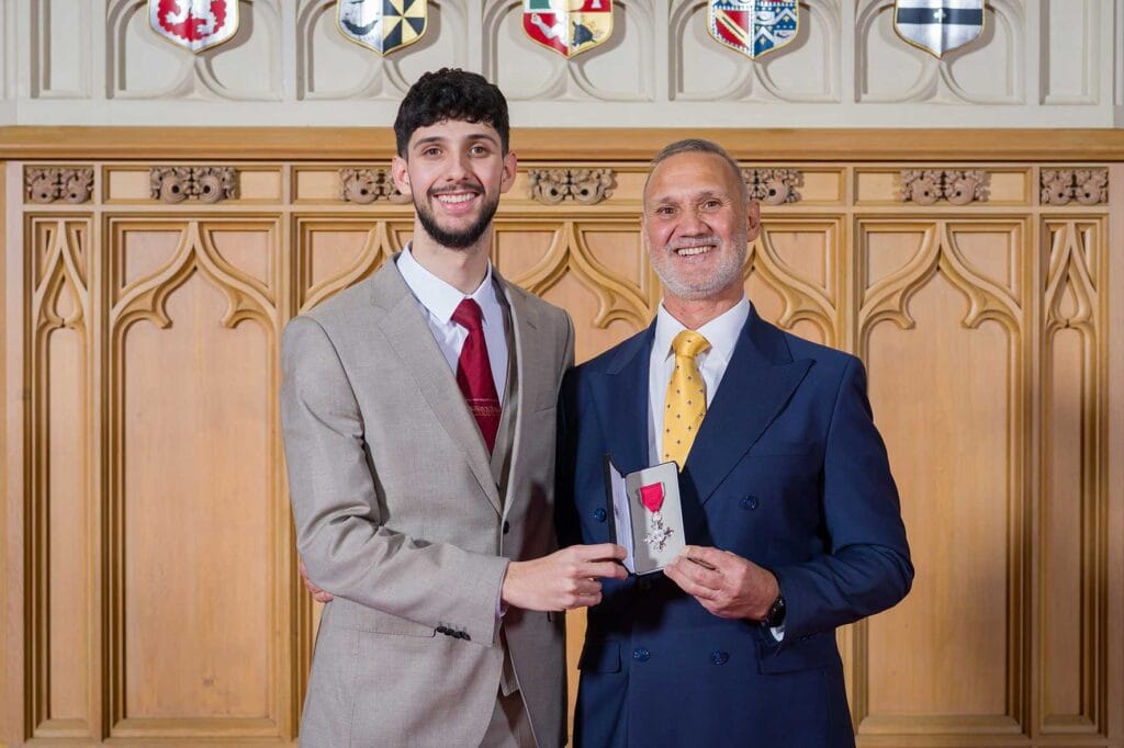 26054-25070-32_HIREZ-1 | Business MK Gamiel Yafai MBE with his son at Windsor Castle following the investiture ceremony.
