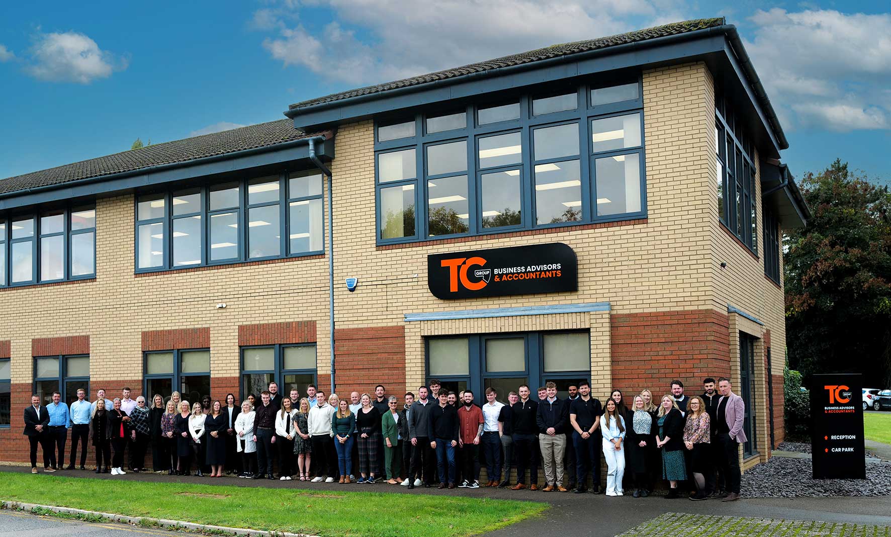 Employees from TC Group stand outside the firm's Northampton office following its inclusion in The Sunday Times Best Places to Work list.