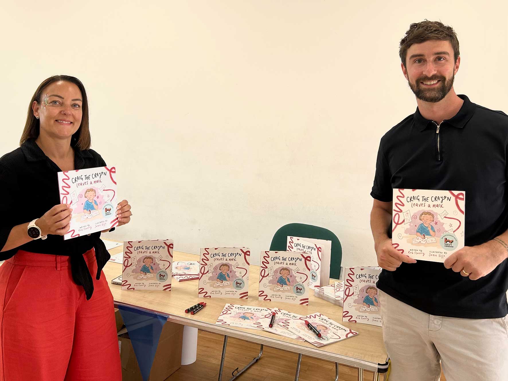 Rob Flannery and Harry's Rainbow founder Odette Mould with copies of Craig the Crayon Leaves a Mark in Milton Keynes.