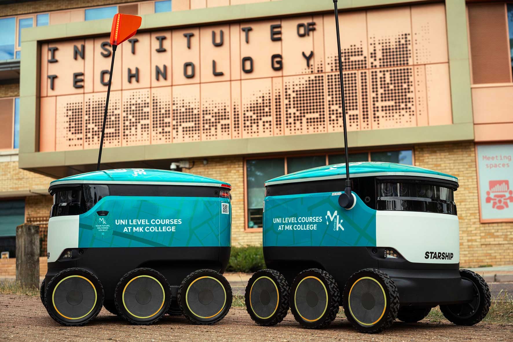 Starship delivery robots promoting Milton Keynes College university-level courses outside the South Central Institute of Technology in Milton Keynes.