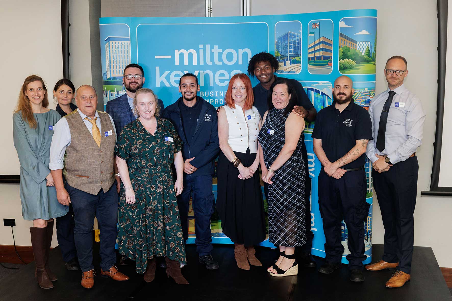 Group posing in front of a MyMiltonKeynes Business Improvement District backdrop at its business plan launch.